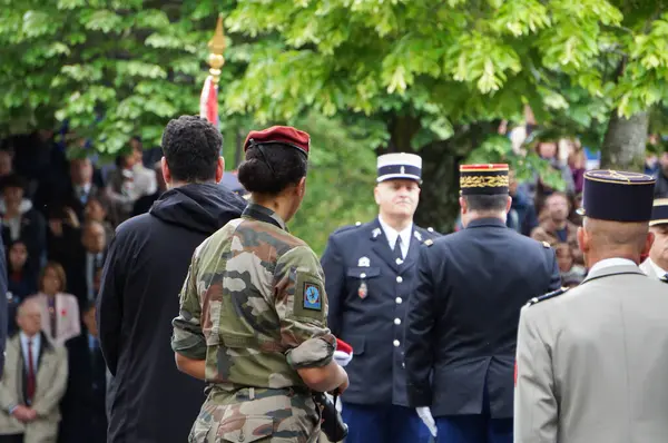 Stock image Toulouse, France - May 8, 2024 - A military female photographer with the French Army takes pictures while Gendarmerie officers are awarded honorary decorations, at the ceremony for Victory Day