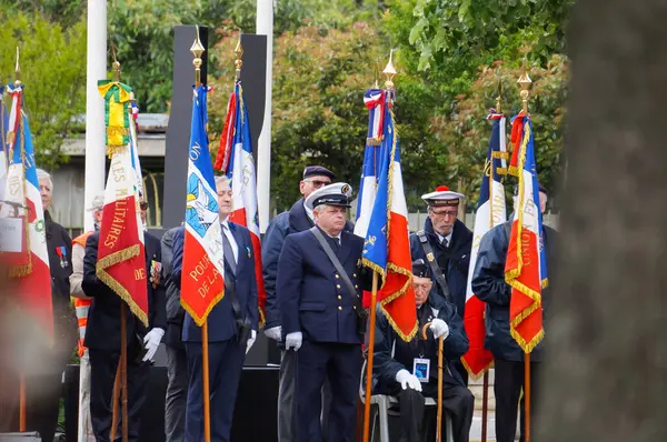 stock image Toulouse, France - May 8, 2024 - French Armed Forces veterans in dress uniforms participate to the Victory Day military ceremony at the War Memorial as flag bearers, holding embroidered standards