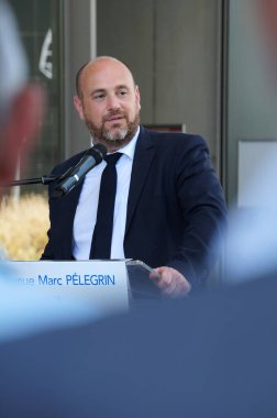 Toulouse, France - July 11, 2024 - District mayor, deputy-mayor of Toulouse Emilion Esnault'speech at the inauguration of Marc Plegrin Avenue at ISAE-SUPAERO, named after the name its first director clipart