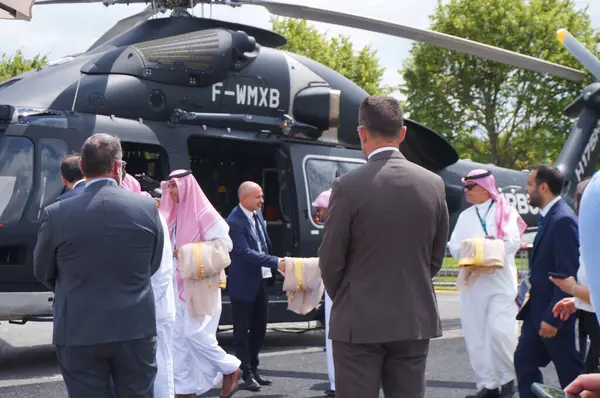 stock image Paris Nord Villepinte, France - June 25, 2024 - Airbus staff and bodyguards attend the visit of an official delegation, likely from Saudi Arabia, at the booth of Airbus Helicopters at Eurosatory Show