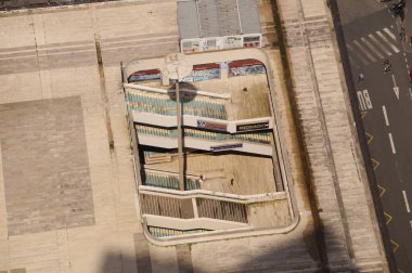 Paris, France - June 22, 2024 - Top view showing an access to the underground Montparnasse Rive Gauche shopping arcade, with dilapidated outdoor stairs going below the slab of Montparnasse Tower clipart