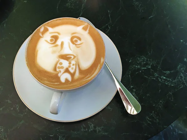 Cappuccino with a cougar head drawn on the foam