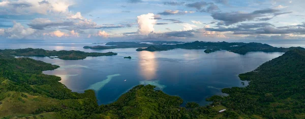 The last light of day illuminates clouds drifting above remote islands in the Solomon Islands. This beautiful country is home to spectacular marine biodiversity and many historic WWII sites.