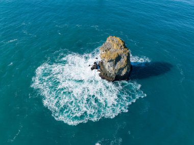 A lone sea stack lies off the Samuel H. Boardman State Scenic Corridor on the southern coast of Oregon. Sea stacks are formed by erosive forces, such as waves crashing, on a headland.