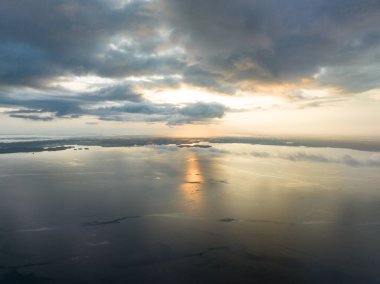 Pasifik Okyanusu 'nu aydınlatacak sakin bir gün doğumu Fak Fak, Batı Papua, Endonezya' dan çok uzak değil. Bu uzak tropikal alan olağanüstü deniz biyolojik çeşitliliğine ev sahipliği yapar..