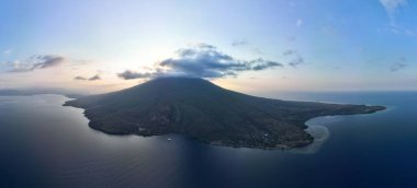 Evening light illuminates the volcano of Iliape on the island of Lembata in Indonesia. This active volcano, within the Lesser Sunda Islands, is part of the Ring of Fire and the Coral Triangle. clipart