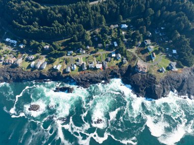 The Pacific Ocean washes against the rocky and rugged coastline of Oregon, not far south of Lincoln City. This part of the Pacific Northwest coast is incredibly scenic and accessed from highway 101. clipart