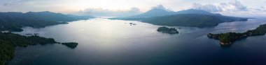 The sun sets over Lembeh Strait, separating North Sulawesi from Lembeh Island. This tropical area is home to a plethora of marine biodiversity and is popular among divers. clipart