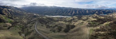 Sunlight shines on the rolling hills near Del Valle regional park in Livermore, California. This scenic area, east of San Francisco Bay, has many wineries and other agriculture. clipart