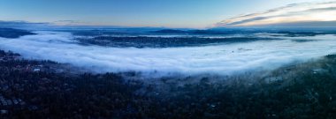 Early morning light illuminates a layer of fog covering the Willamette River and much of the valley it runs through in Oregon. The Pacific Northwest receives plenty of fog throughout the year.