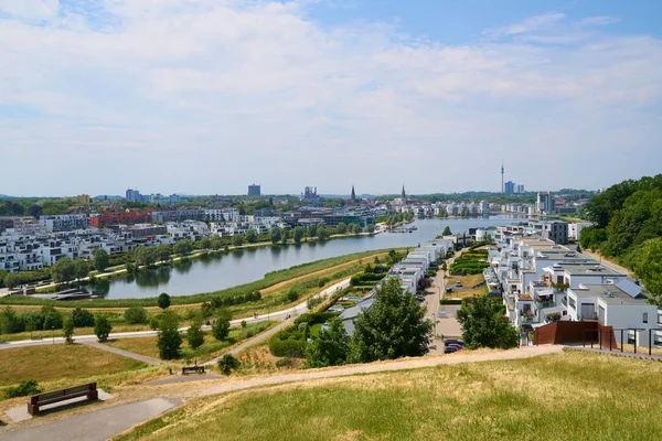 stock image Dortmund, Germany - 06.18.2023: View over the Phnixsee in Dortmund Hrde. The lake was artificially created on the Phoenix east  steelworks. The stadium and disused industrial sites can be seen.                             