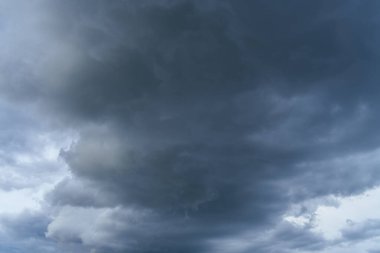 Dark gray clouds in the sky. Epic nature picture. Can be used as a background, poster and more. There is also space for text. clipart