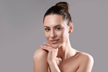 Beautiful young woman with clean perfect skin. Portrait of beauty model with natural nude make up. Spa, skincare and wellness.  clipart