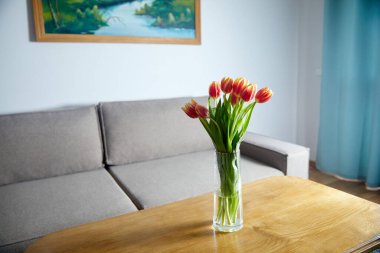 Bouquet of beautiful tulip flowers on table in living room