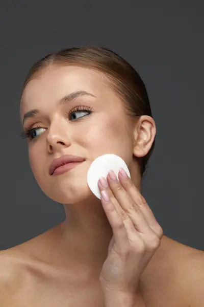 Woman Cleaning Face With White Pad. Beautiful Cute Girl Removing Makeup White Cosmetic Cotton Pad.