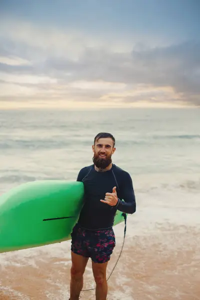 Surfer Met Surfplank Het Strand Bij Zonsondergang Gelukkig Man Guy Rechtenvrije Stockafbeeldingen