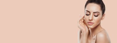 Beautiful woman portrait, skin care concept, Skin care. Dermatology. Portrait of female hands with manicure nails touching her face. Spa. Girls cosmetics. Facial treatment. Panorama, baner With Copy Space