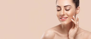 Beautiful young woman with clean perfect skin. Portrait of beauty model with natural nude make up and touching her face. Panorama, baner With Copy Space