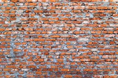 Kırsal Kırmızı Tuğla Duvar dokusu. Duvar, kırmızı, turuncu ve gri tonlarında kaba bir doku sergiliyor. Arkaplan, mimari tasarımlar veya endüstriyel temalı projeler için ideal