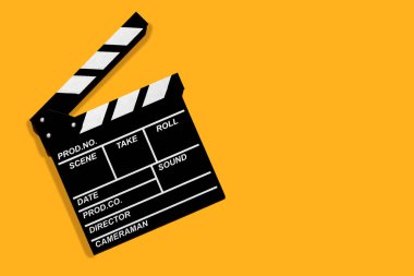 Turuncu arkaplan fotokopi alanı üzerinde video ve film çekmek için alkış.
