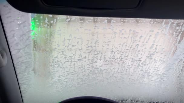 圧力下のクリーンな水の流れ 車の洗車 フロントガラスを通しての眺め ロボット洗車を使用した洗車 — ストック動画