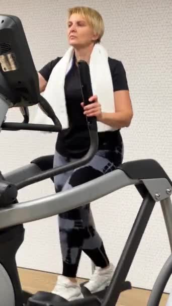 Frau Mittleren Alters Trainiert Auf Einem Crosstrainer Ihre Armmuskulatur Stärken — Stockvideo