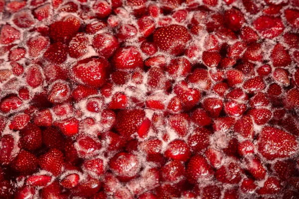 Process of making homemade raspberry jam. Red sweet syrup boiling on the stove closeup. Strawberry jam looks very appetizing. Boiling homemade strawberry jam. Make a strawberry jam.