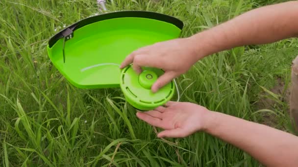 Replacing Coil Lawn Mower Gardener Attaching Reel Line Lawn Mower — Stock Video