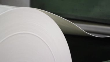 Fabrika ortamında gelişmiş bir endüstriyel makinede önemli miktarda plastik makara. Gelişmiş teknoloji ve verimli makinelerle modern plastik rulo imalatı.