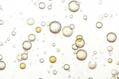 Sarı köpük bir bardakta akıyor. Bulanık arkaplan, uçuyor.