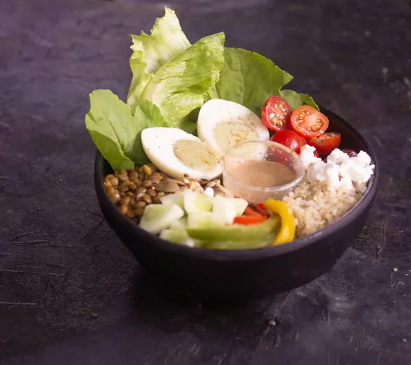 stock image Egg salad with fresh vegetables such as beans, corn, horse gram and mint olive dressing on the side. protein salad served in a white bowl