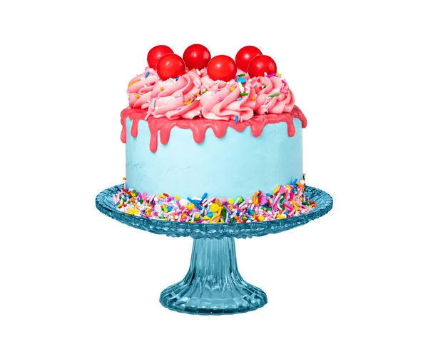 Birthday Drip Cake on a stand with red ganache, colorful sprinkles and cherry balls isolated on a pure white background. Fun, trendy and a bit retro.