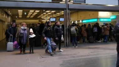 January 22, 2023 - Paris, France. Many people enter and exit the subway station. Passengers with suitcases go back and forth.