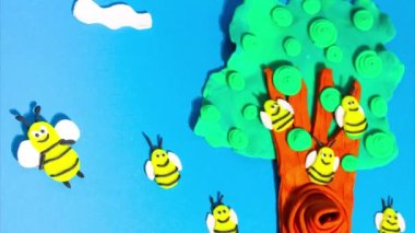 Stop motion animation from plasticine. Bees fly near a beehive on a tree in the forest. Claymotion cartoon