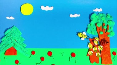 Stop motion animation from plasticine. Bees attack a bear near a beehive in a tree. Claymotion cartoon.