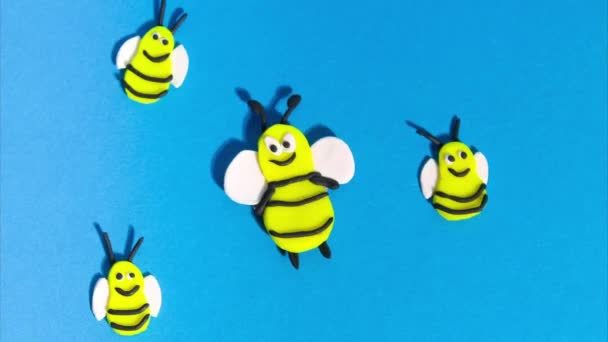 Stop Motion Animation Plasticine Cheerful Funny Bees Flying Blue Background — Vídeos de Stock