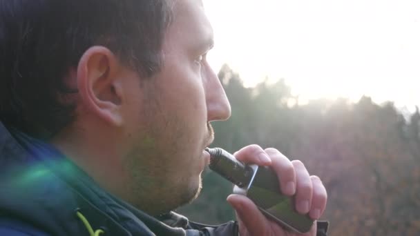 Handsome Young Man Beard Inhales Smoke Electronic Cigarette Street — Vídeo de stock