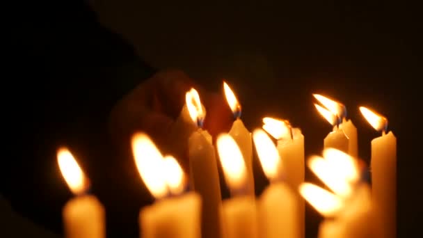 Long White Religious Candles Flames Burning Night Church Womans Hand — Stock Video