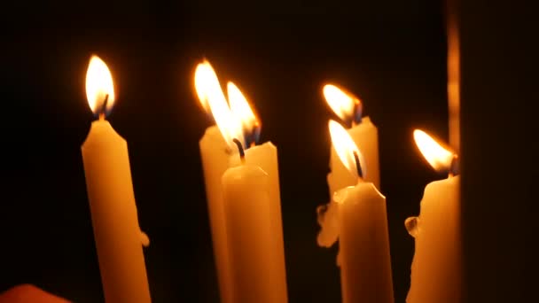 Long White Religious Candles Flames Burning Night Church Womans Hand — Αρχείο Βίντεο