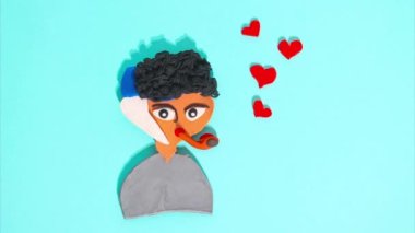 February 15, 2023 - Kehl, Germany: Stop motion animation of plasticine for Valentines Day, the main character in hearts moving on a blue background. Claymotion famous character in art