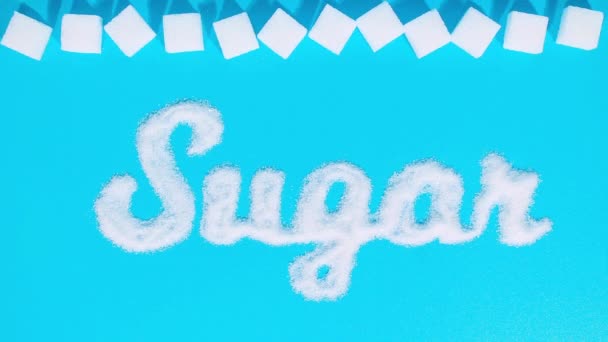 停止动作动画 用细砂糖在字体上刻上字母 糖立方体出现并消失以产生一个有趣的运动 糖的消费问题 — 图库视频影像