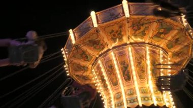 Gece vakti bir lunaparkta ağır çekimde atlı karınca. Eğlence parkında tatil eğlencesi.