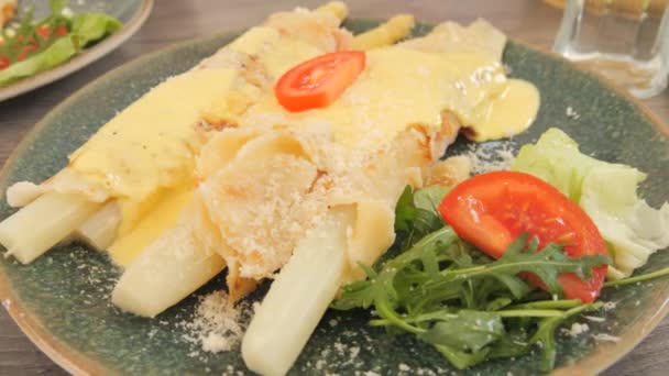 レストランで白いアスパラガスを食べる ホワイトアスパラガス パンケーキ ベーコン ソース グルメのための春の食べ物 — ストック動画