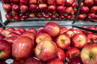 A pile of fresh ripe red apples in the supermarket