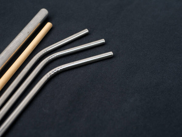 Bamboo and steel straws, an alternative to reducing plastic straws. The concept of reducing non-degradable plastic waste.