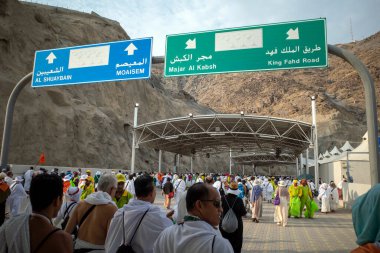 Mecca, Saudi Arabia - June 16, 2024: Pilgrims walking towards the Jamarat stoning ritual in Mina, Saudi Arabia during the Hajj season. clipart