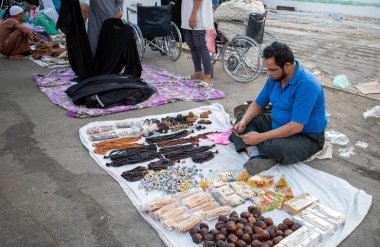 Mecca, Saudi Arabia - June 16, 2024: Souvenir sellers near the hajj tents in Mina, Saudi Arabia during the Hajj season. clipart