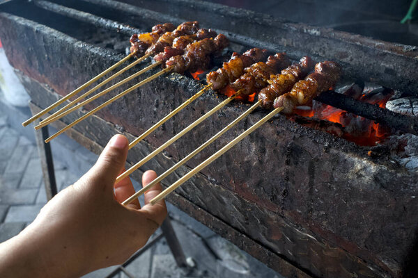Sate Kambing or Lamb Satay, a traditional satay from Jogyakarta, Indonesia, in shallow focus.