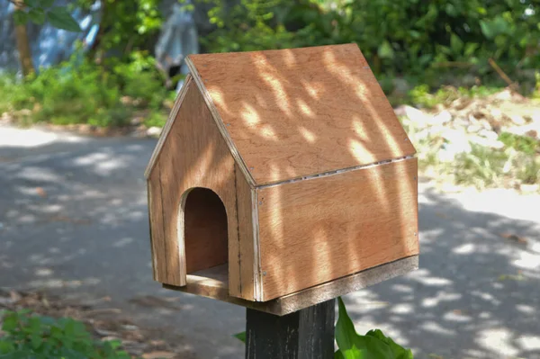 Wooden mail box at the roadside. Classic design.