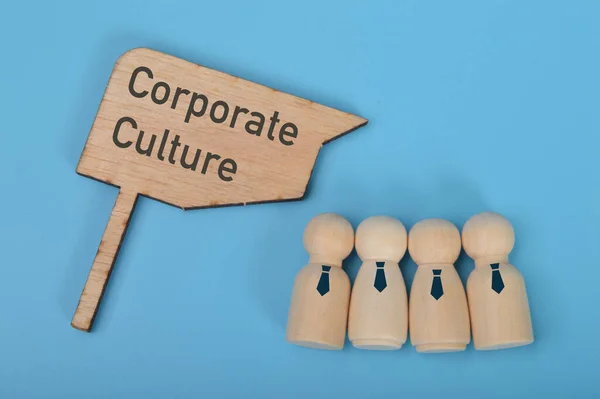 Wooden doll figures standing with text CORPORATE CULTURE.